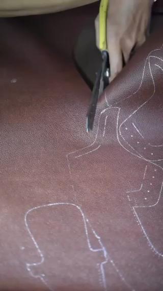 Hands cutting leather patterns for handmade HAJINK shoes